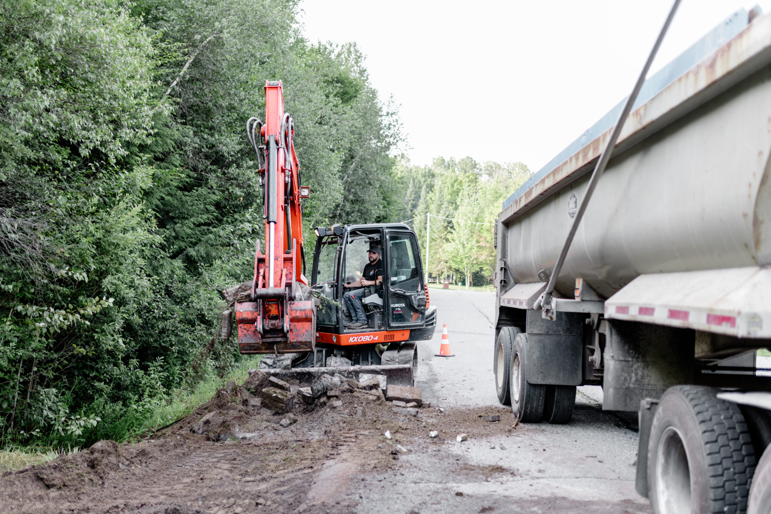 Excavatrice orange AB et camion sur un chantier